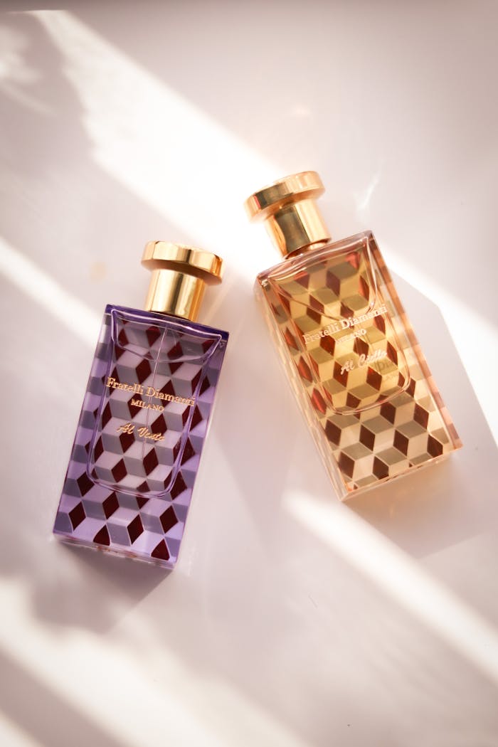 Elegant geometric perfume bottles captured in warm, natural light for a sophisticated look.